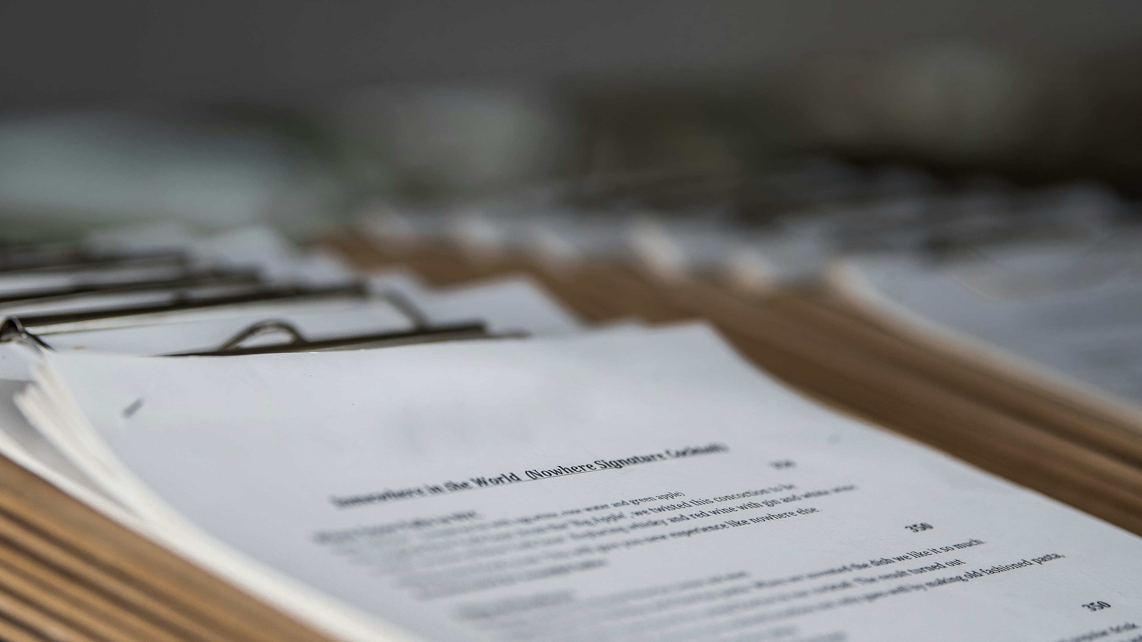 Stack of wooden clipboards with paper forms, photographed in close-up